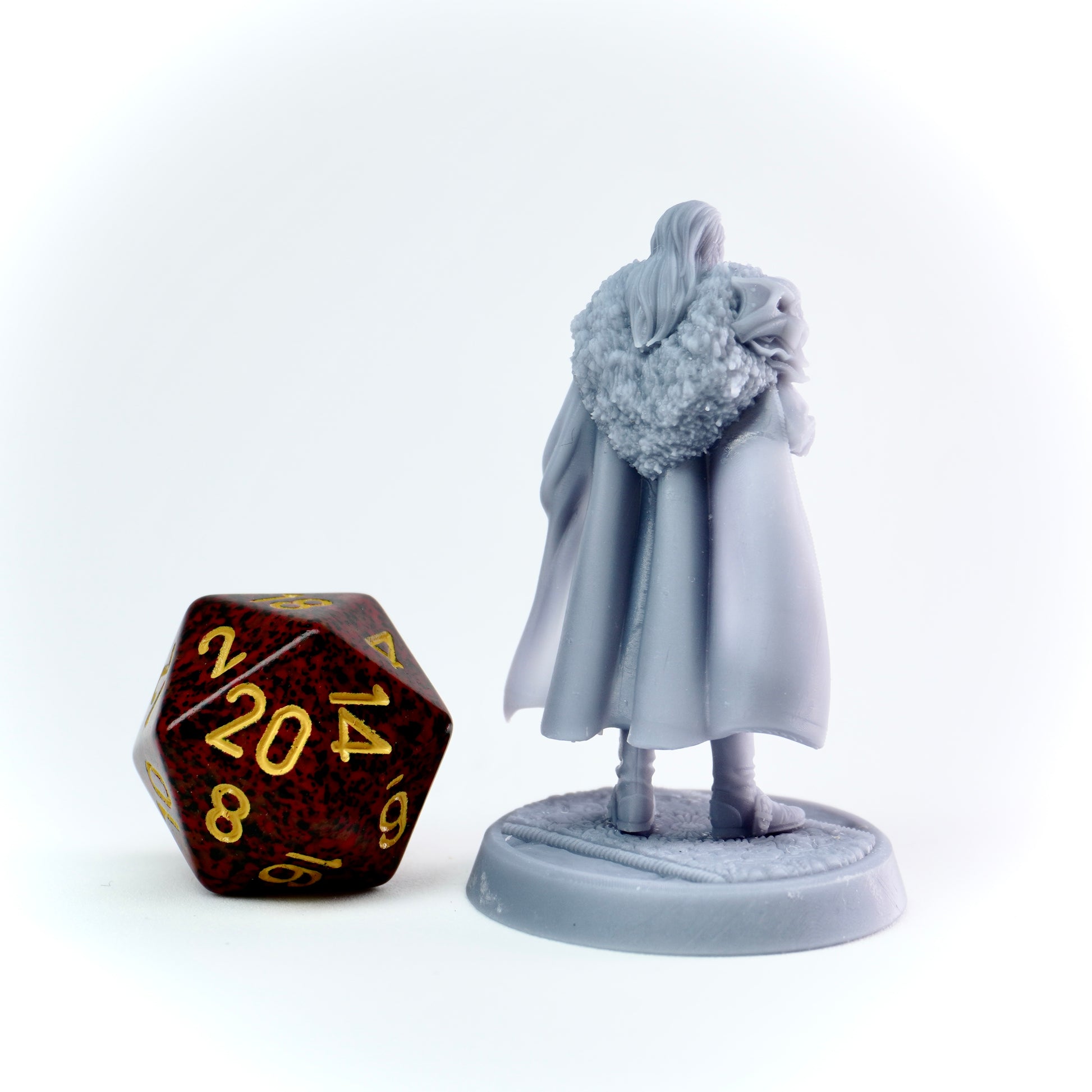 Gray figurine with a large dice on a white background