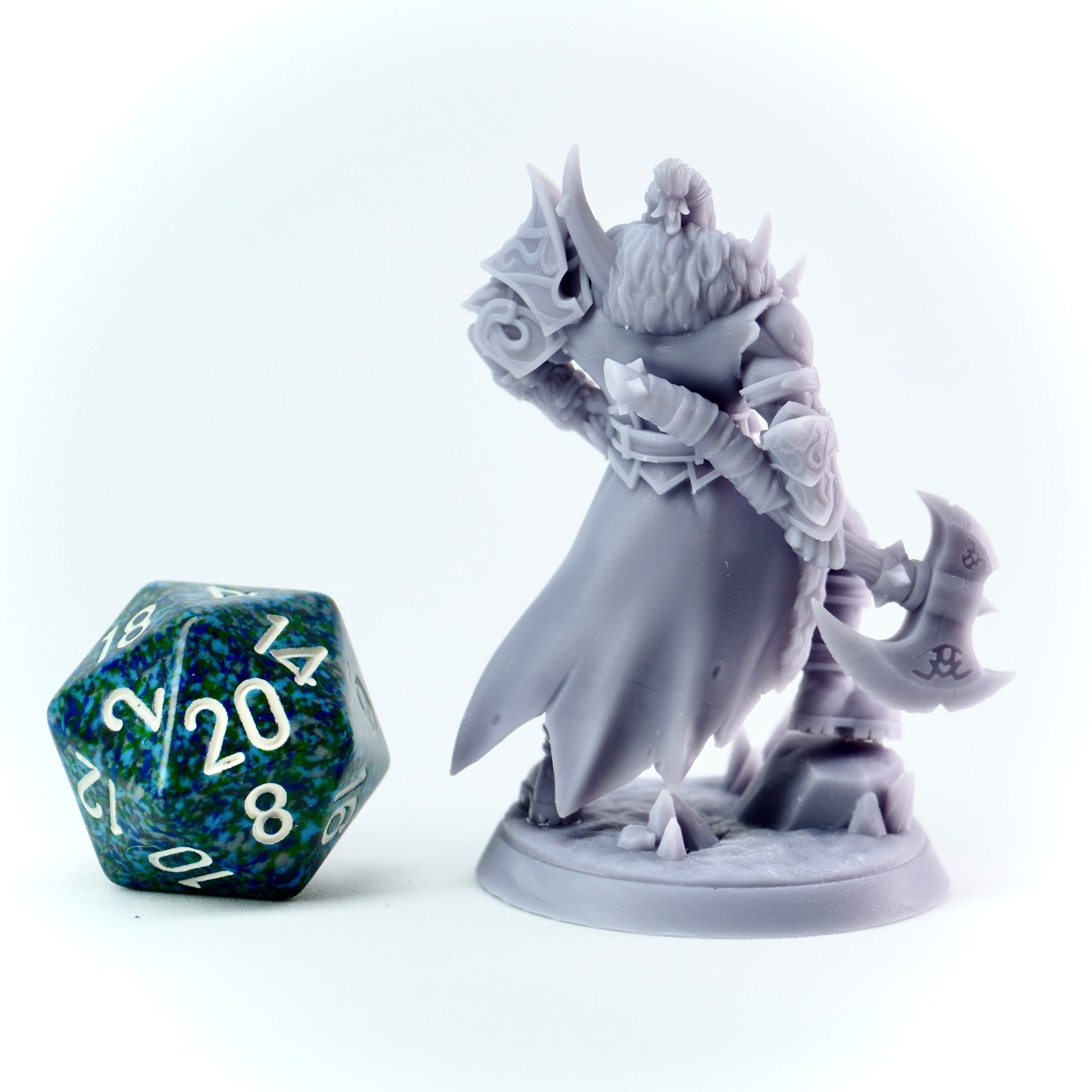 Gray fantasy barbarian figurine with a large dice on a white background
