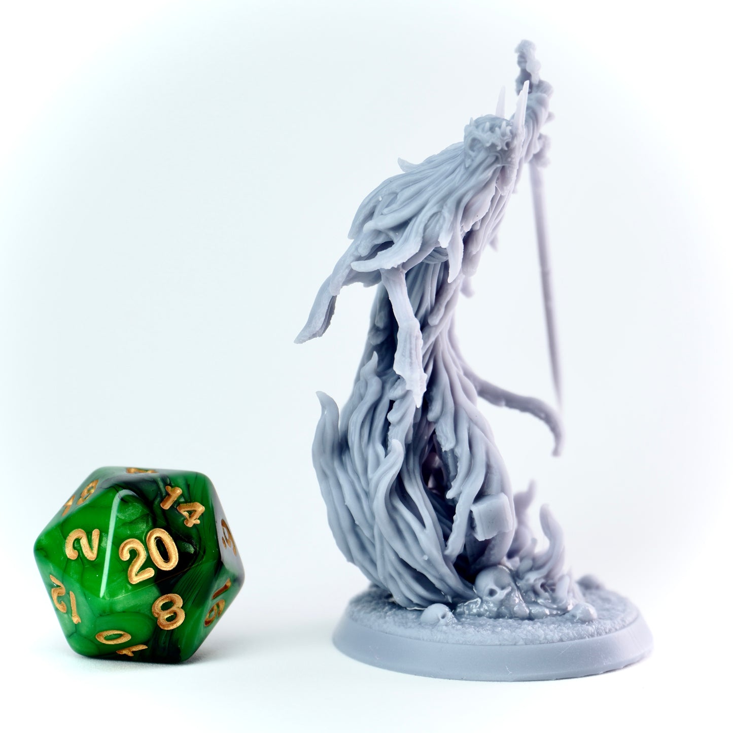 Gray fantasy figurine with a longsword on a white background