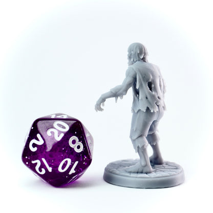 Gray zombie figurine and purple polyhedral dice on a white background