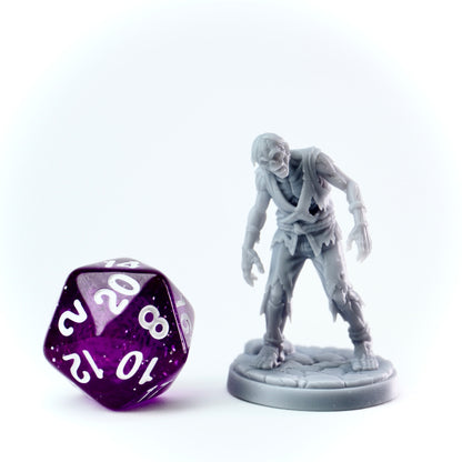 Zombie figurine and purple polyhedral dice on a white background