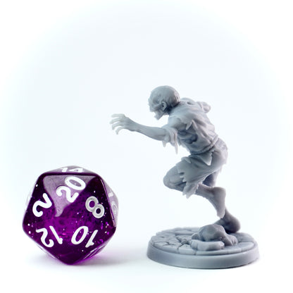 Gray zombie figurine and purple dice on a white background
