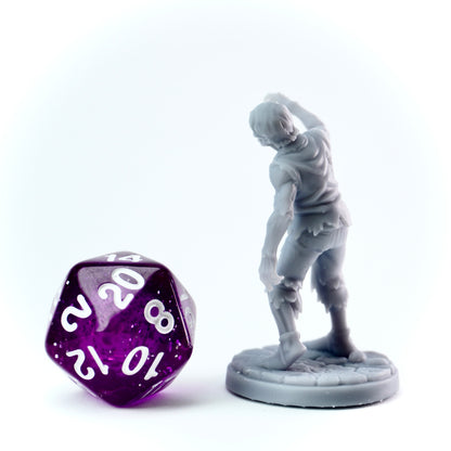 Gray figurine of a zombie character next to a purple polyhedral dice on a white background