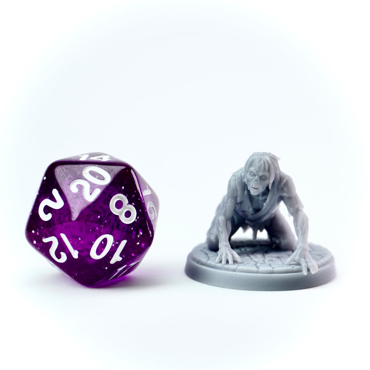 Purple polyhedral dice with white numbers next to a gray miniature figure on a white background