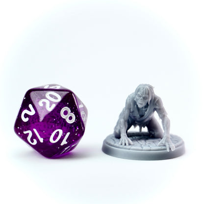 Purple polyhedral dice with white numbers next to a gray miniature figure on a white background