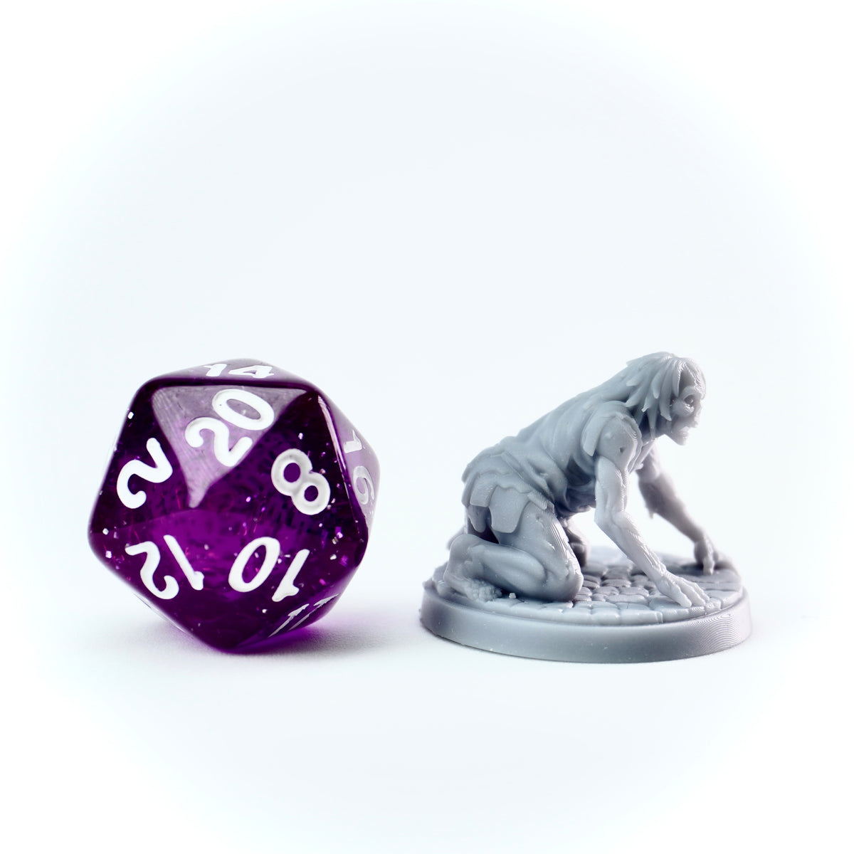 a gray miniature zombie figurine on a white background